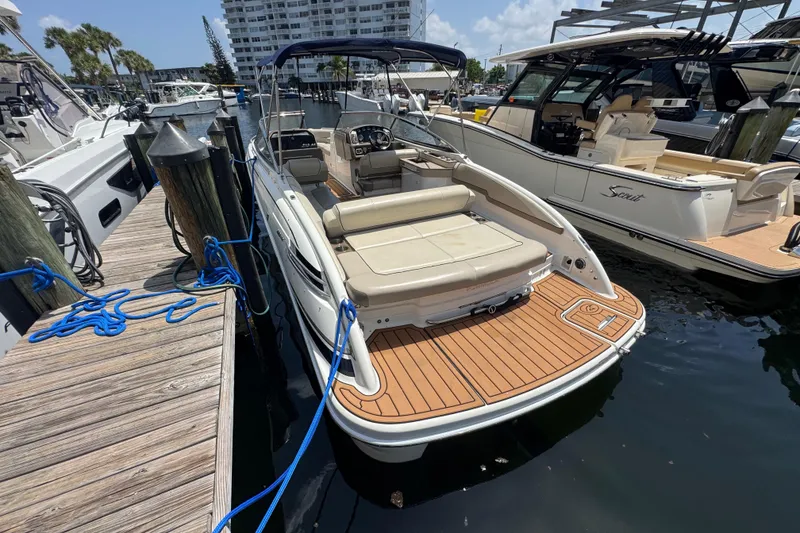 Slide: The Image of 2019 Formula 270 Bowrider docked at marina, featuring spacious seating and sleek design. - 49