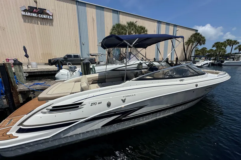 Slide: The Image of 2019 Formula 270 Bowrider boat docked at a marina under a clear sky. - 7