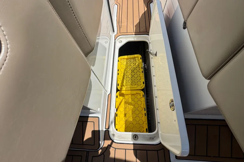 Slide: The Image of Open storage compartment on 2019 Formula 270 Bowrider boat with yellow containers inside. - 40
