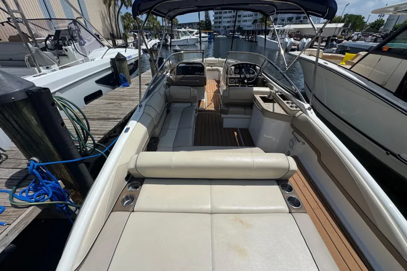 Slide: The Image of 2019 Formula 270 Bowrider boat docked, featuring spacious seating and modern design. - 15