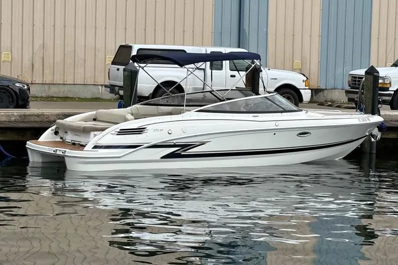 Slide: The Image of 2019 Formula 270 Bowrider boat docked at marina, featuring sleek design and canopy. - 2