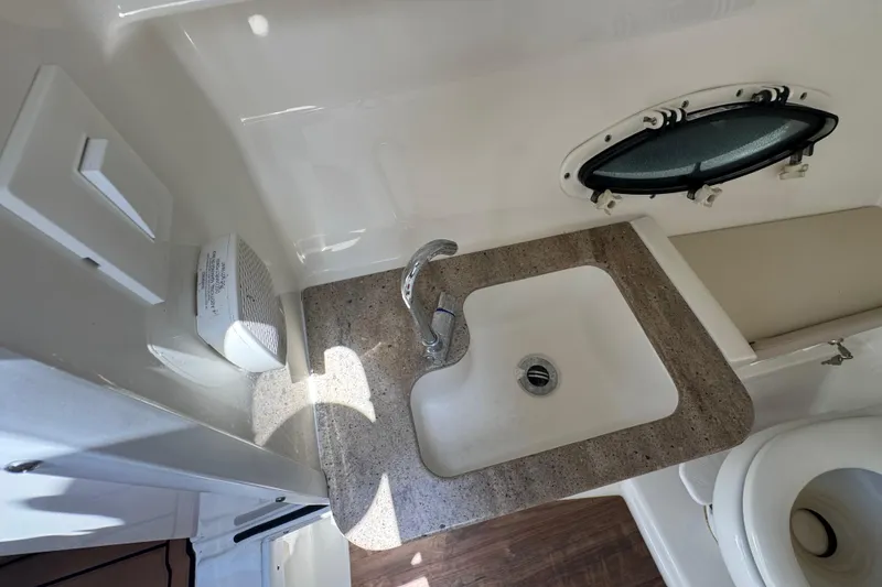 Slide: The Image of 2019 Formula 270 Bowrider boat interior with sink, faucet, and porthole window. - 31