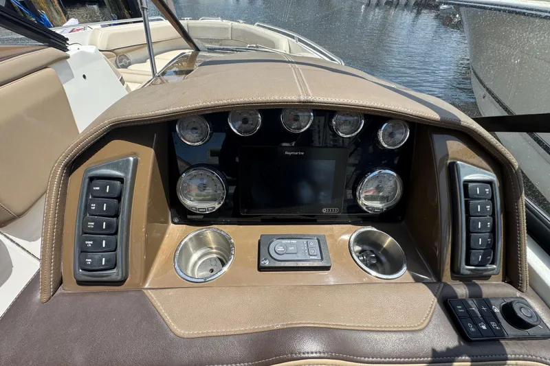Slide: The Image of 2019 Formula 270 Bowrider dashboard with gauges, controls, and navigation screen. - 33