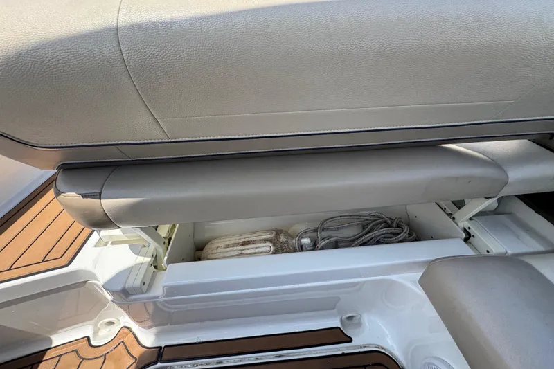 Slide: The Image of 2019 Formula 270 Bowrider storage compartment with ropes and fender, featuring cushioned seating. - 20