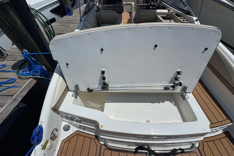 Slide: The Image of 2019 Formula 270 Bowrider boat with open storage compartment at dock. - 16