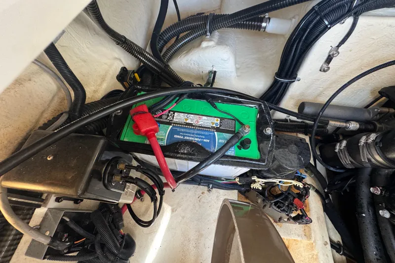 Slide: The Image of Battery compartment of a 2019 Formula 270 Bowrider with wiring and connections visible. - 56