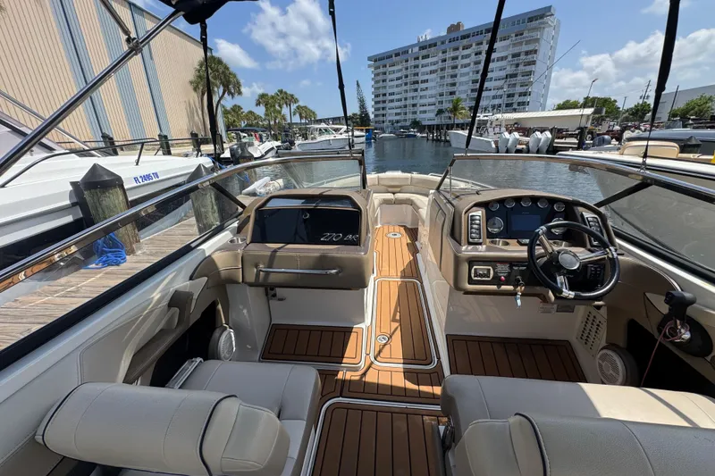 Slide: The Image of 2019 Formula 270 Bowrider boat interior with modern dashboard and seating at marina. - 23