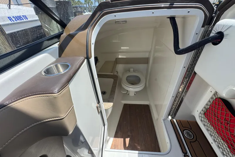 Slide: The Image of 2019 Formula 270 Bowrider boat interior with compact bathroom and seating area. - 29