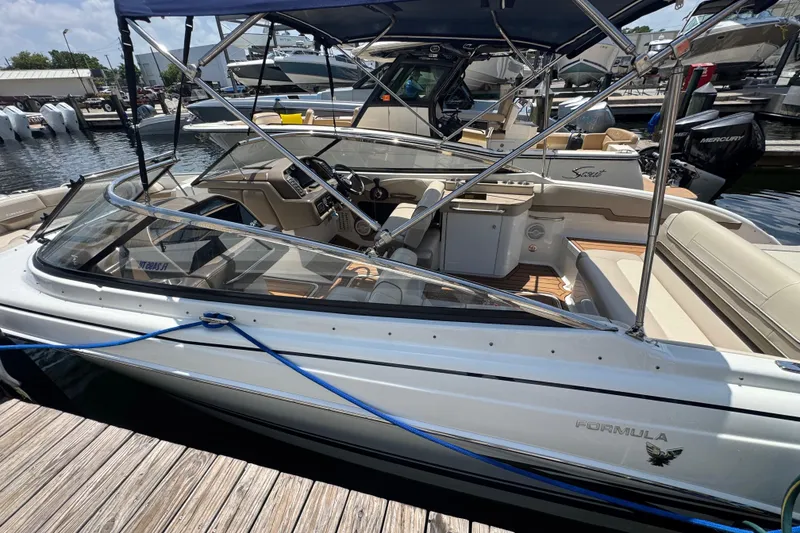 Slide: The Image of 2019 Formula 270 Bowrider boat docked at marina, featuring sleek design and spacious seating. - 11