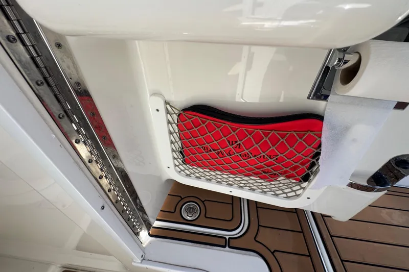 Slide: The Image of Storage compartment on a 2019 Formula 270 Bowrider boat with red pouch and netting. - 30