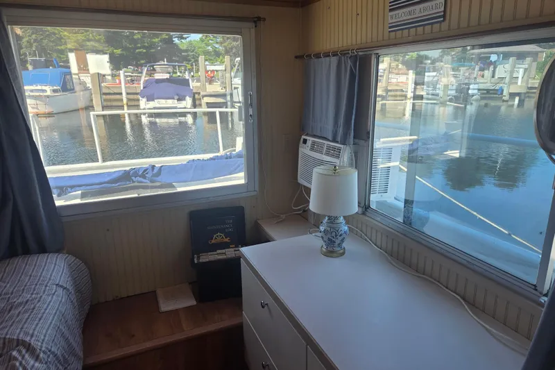 Slide: The Image of Interior of 1973 River Queen Star Stream houseboat with marina view through large windows. - 18