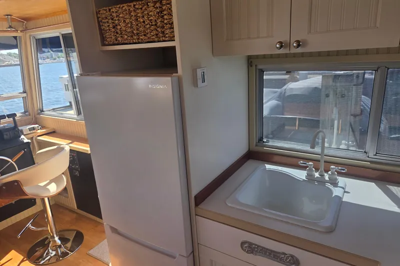 Slide: The Image of Interior of a 1973 River Queen Star Stream boat with kitchen sink and Insignia fridge. - 14