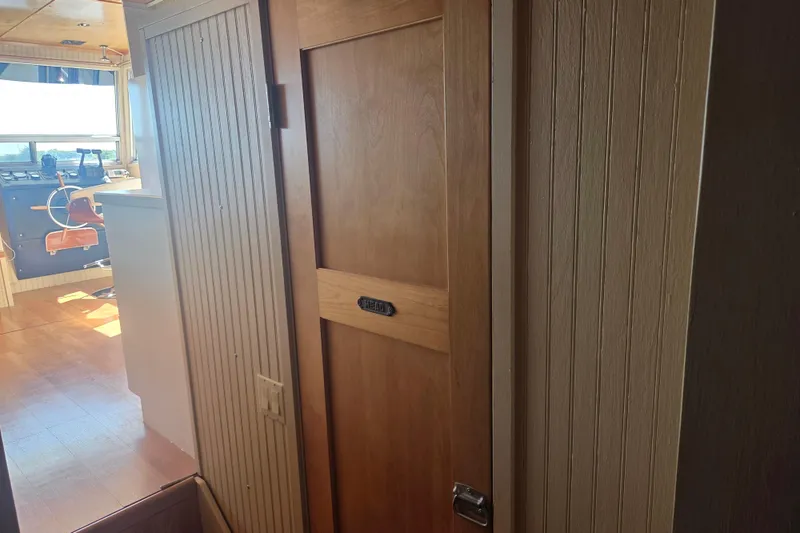 Slide: The Image of Interior of a 1973 River Queen Star Stream boat, featuring a wooden door and helm area. - 19