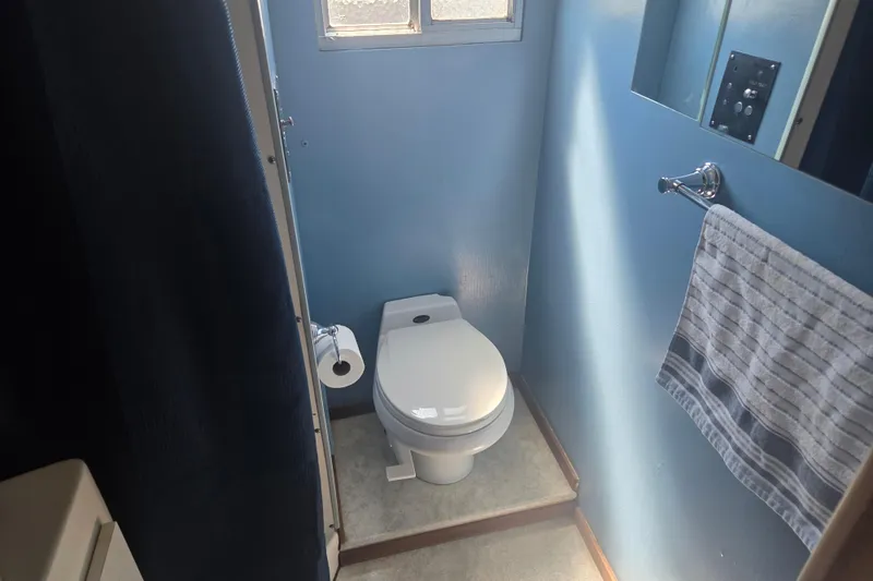 Slide: The Image of Small blue bathroom in 1973 River Queen Star Stream boat with toilet and towel. - 21
