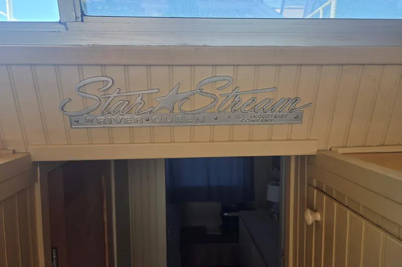 Slide: The Image of 1973 River Queen Star Stream interior with vintage logo above doorway. - 15
