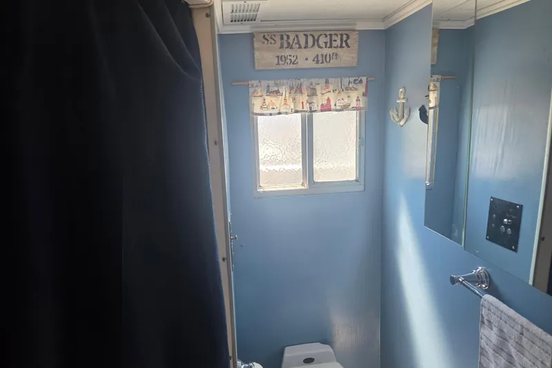 Slide: The Image of Small bathroom with nautical decor in a 1973 River Queen Star Stream boat. - 22
