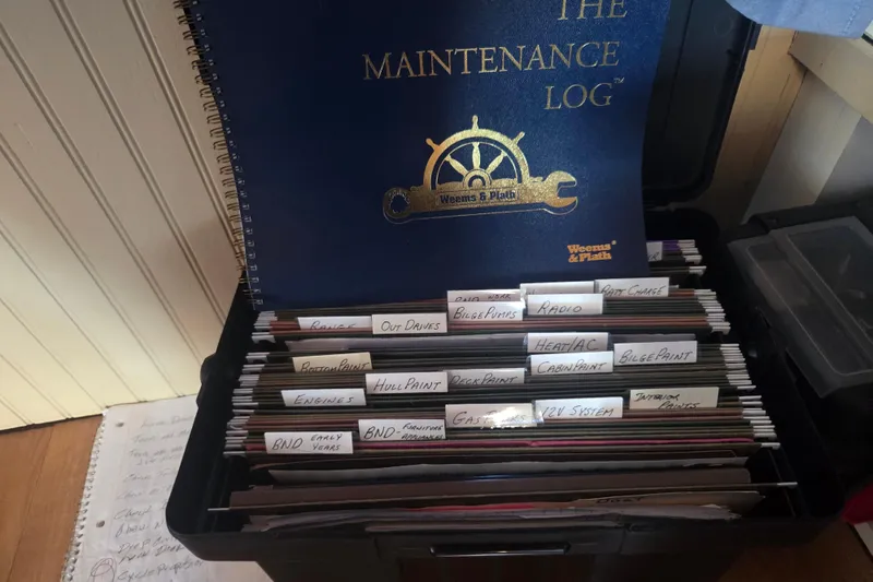 Slide: The Image of Maintenance log and organized files for 1973 River Queen Star Stream boat. - 25