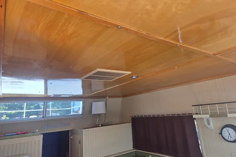 Slide: The Image of Interior of a 1973 River Queen Star Stream boat with wooden ceiling and window. - 26