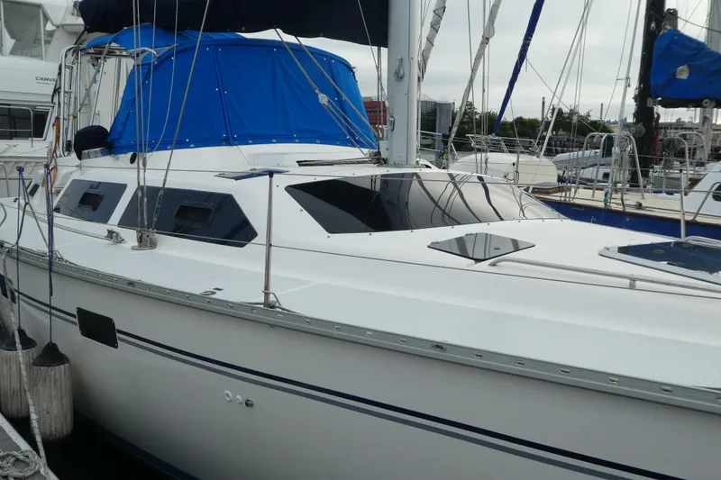 Slide: The Image of 1992 Hunter Passage 42 sailboat docked with blue canopy and sleek design. - 2