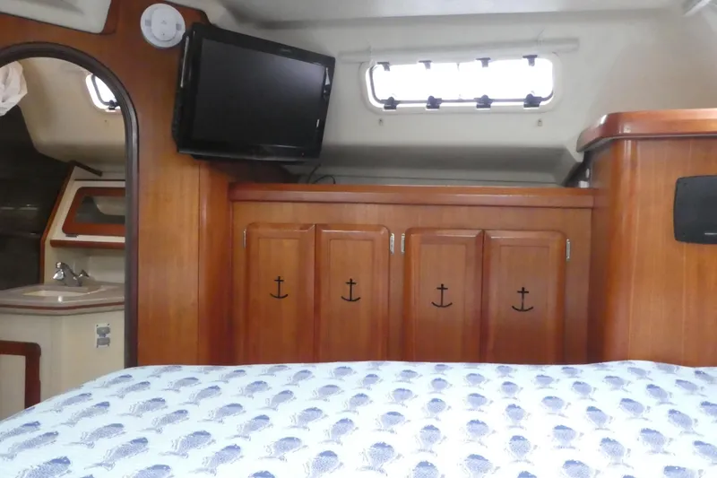 Slide: The Image of Interior of 1992 Hunter Passage 42 yacht with wood cabinetry and mounted TV. - 23