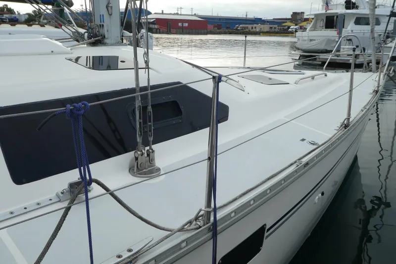 Slide: The Image of 1992 Hunter Passage 42 sailboat docked in a marina, showcasing sleek deck design. - 3