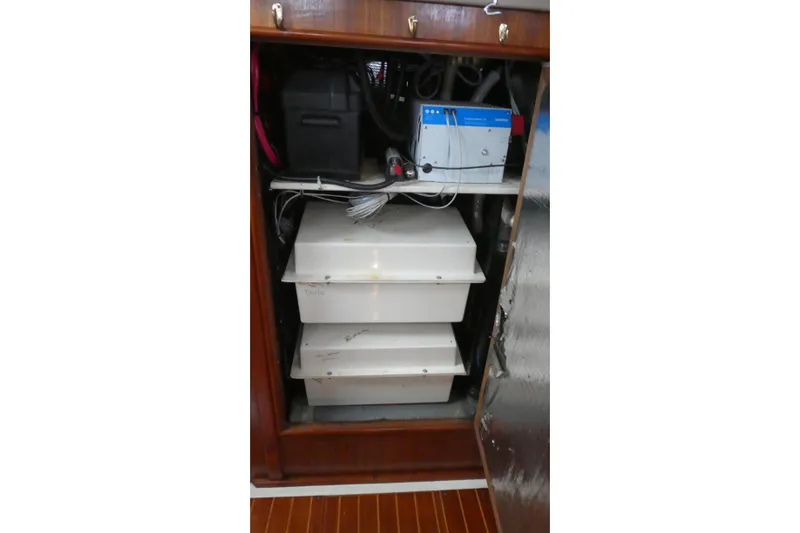 Slide: The Image of Electrical system inside a 1992 Hunter Passage 42 sailboat, featuring batteries and wiring. - 37