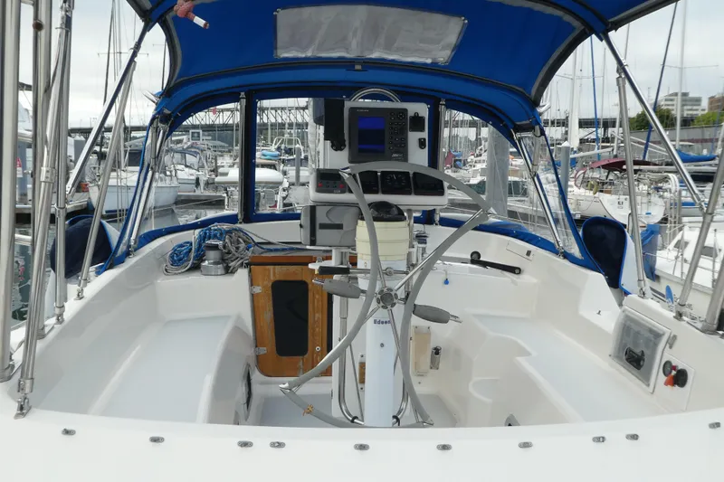Slide: The Image of Cockpit of 1992 Hunter Passage 42 sailboat with blue canopy and steering wheel. - 6