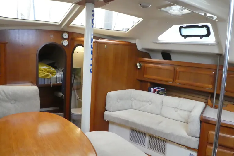 Slide: The Image of Interior of 1992 Hunter Passage 42 sailboat with cozy seating and wooden cabinetry. - 14
