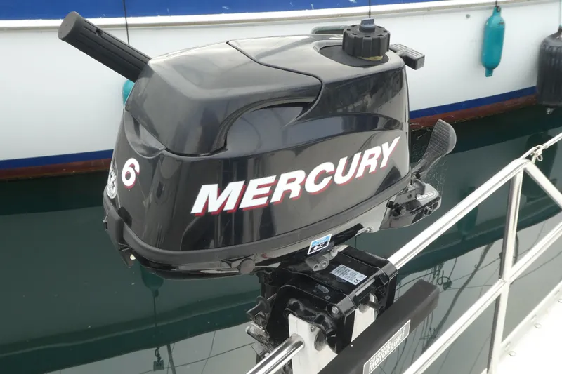 Slide: The Image of Mercury outboard motor on a 1992 Hunter Passage 42 sailboat, docked at a marina. - 41