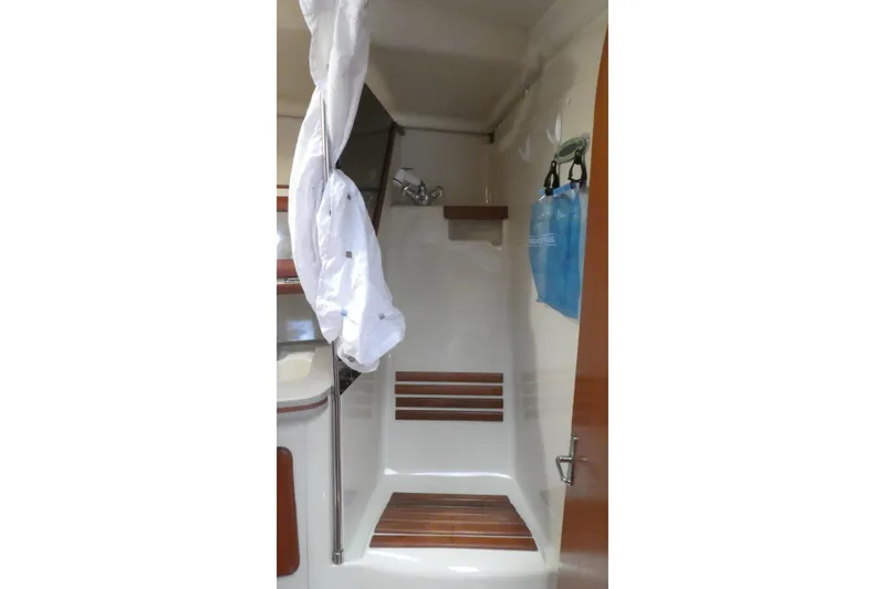 Slide: The Image of Interior of 1992 Hunter Passage 42 sailboat shower area with wooden accents. - 29