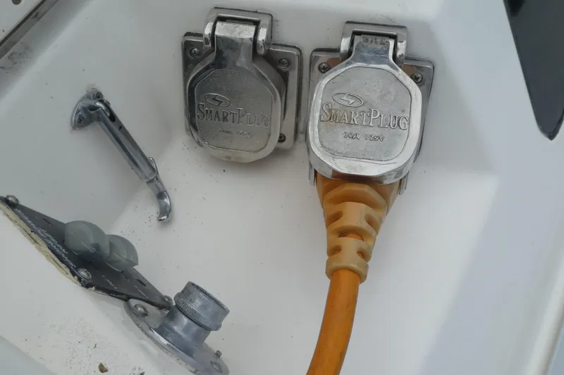 Slide: The Image of SmartPlug electrical connection on 1992 Hunter Passage 42 boat, featuring dual outlets and orange cable. - 40