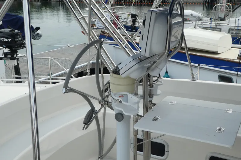 Slide: The Image of Cockpit of 1992 Hunter Passage 42 sailboat with steering wheel and navigation equipment. - 10