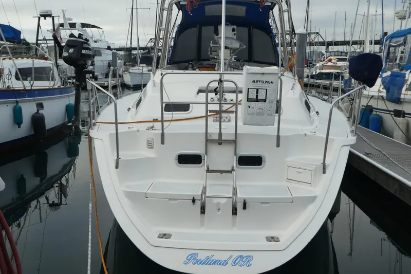 Slide: The Image of 1992 Hunter Passage 42 sailboat docked in marina, rear view with equipment visible. - 42