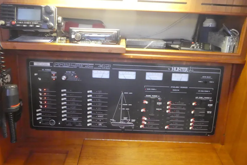 Slide: The Image of Control panel of a 1992 Hunter Passage 42 sailboat with various switches and meters. - 21