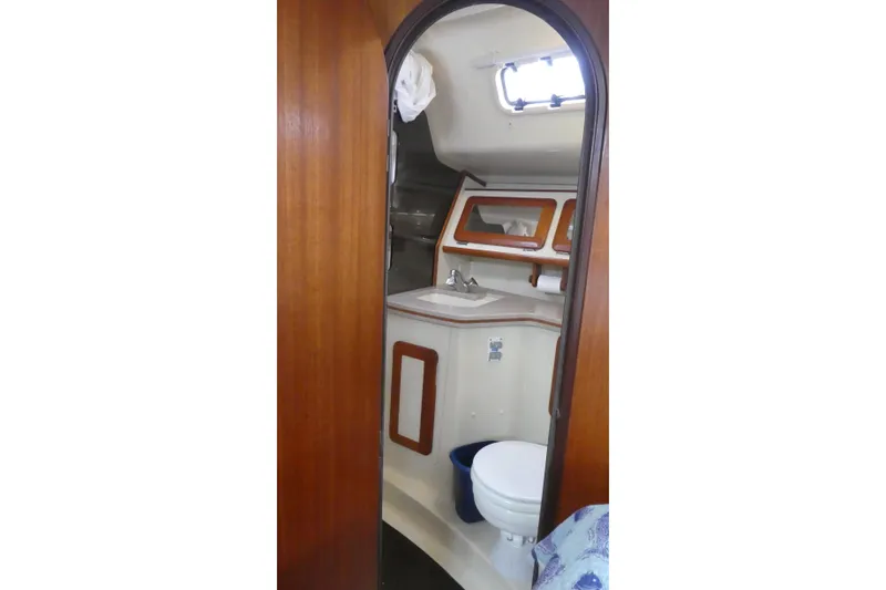 Slide: The Image of Interior view of 1992 Hunter Passage 42 sailboat bathroom with wooden door and compact design. - 25