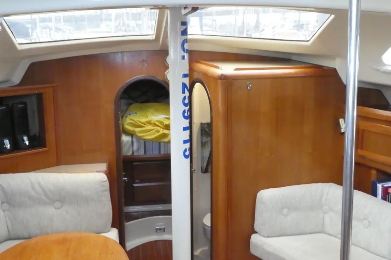 Slide: The Image of Interior of 1992 Hunter Passage 42 sailboat with cozy seating and wooden cabinetry. - 12