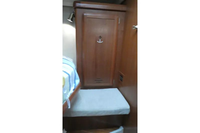 Slide: The Image of Interior of 1992 Hunter Passage 42 sailboat with wooden cabinetry and cushioned seating. - 33
