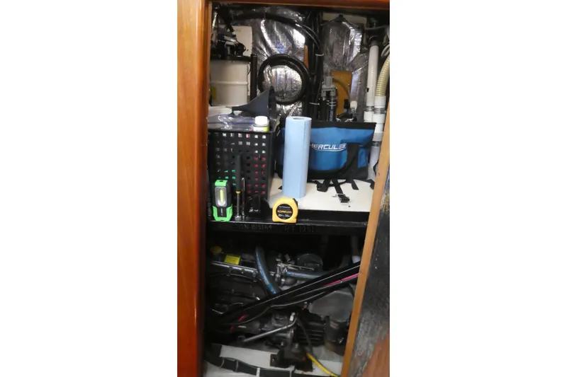 Slide: The Image of Engine room of a 1992 Hunter Passage 42 sailboat with tools and equipment. - 34