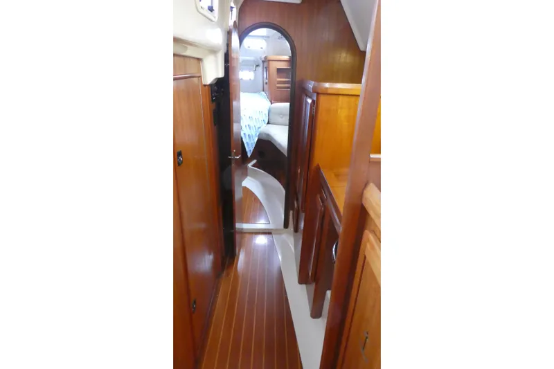 Slide: The Image of Interior view of 1992 Hunter Passage 42 sailboat with wooden cabinetry and flooring. - 18