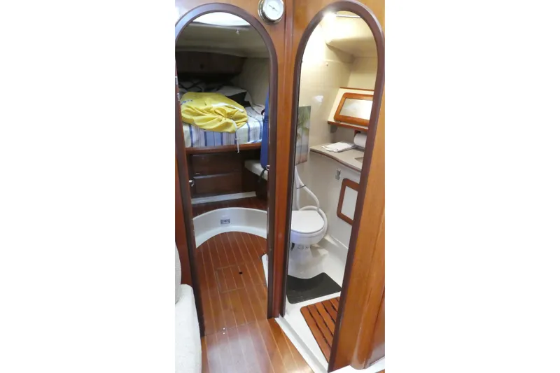 Slide: The Image of Interior of 1992 Hunter Passage 42 yacht showing cabin and bathroom with wooden finishes. - 28