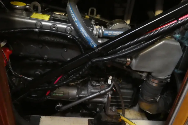 Slide: The Image of Engine compartment of a 1992 Hunter Passage 42 sailboat, showing hoses and components. - 36