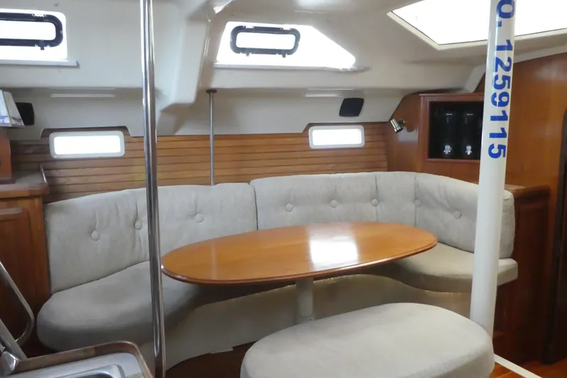 Slide: The Image of Interior of 1992 Hunter Passage 42 sailboat with cozy seating and wooden table. - 13