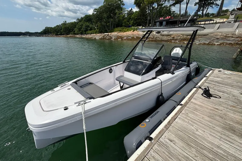 The Image of 2022 Axopar 22 T-Top boat docked by a scenic shoreline. - 0