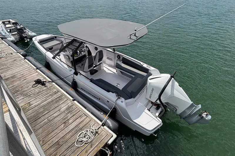 Slide: The Image of An Axopar 22 T-Top boat from 2022 docked at a pier in the water. - 1
