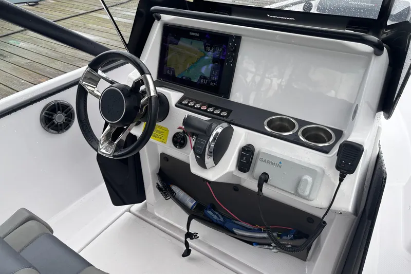 Slide: The Image of 2022 Axopar 22 T-Top boat dashboard with steering wheel and navigation system. - 9