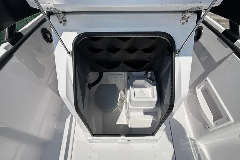 Slide: The Image of 2022 Axopar 22 T-Top boat interior with compact toilet and sink. - 14