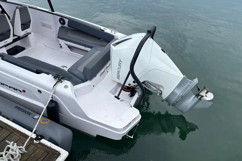 Slide: The Image of 2022 Axopar 22 T-Top boat with Mercury outboard engine, docked on calm water. - 16