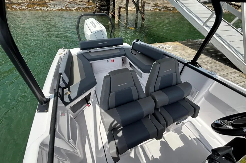 Slide: The Image of 2022 Axopar 22 T-Top boat interior with sleek seating and modern design. - 10