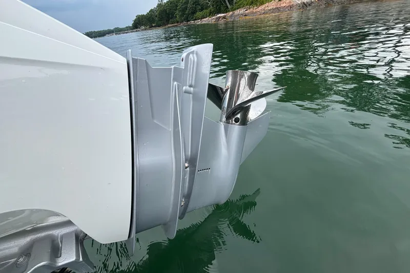 Slide: The Image of Outboard motor of 2022 Axopar 22 T-Top boat in calm water. - 19