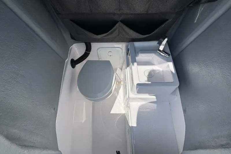 Slide: The Image of Interior of 2022 Axopar 22 T-Top boat with toilet and sink. - 15